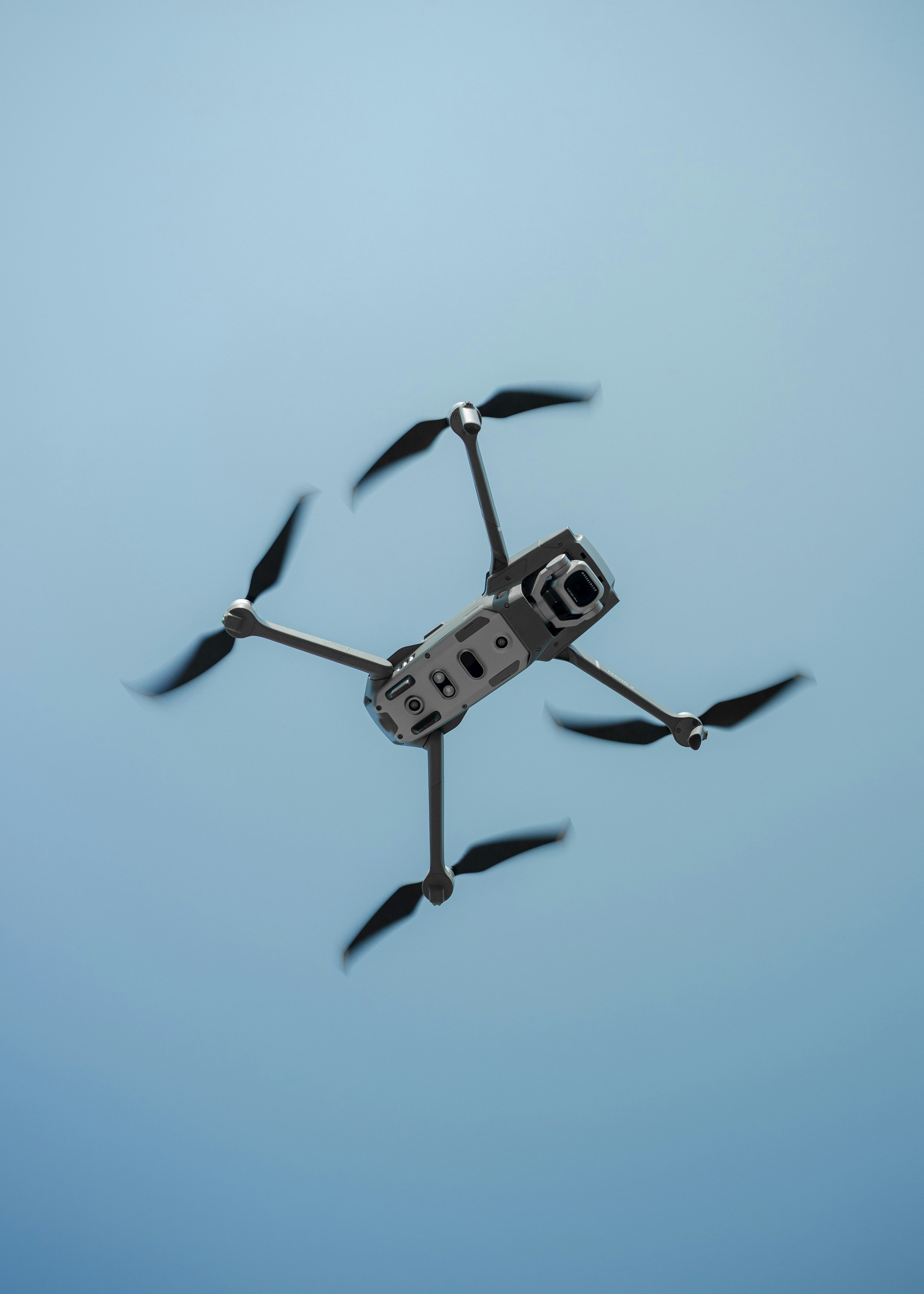 black and white drone in mid air